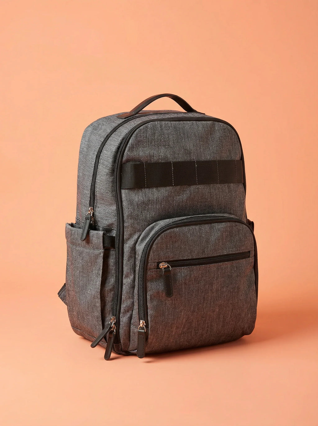 Bebefit Multipurpose Diaper Bag Backpack in dark grey on peach background, bebefit.eu