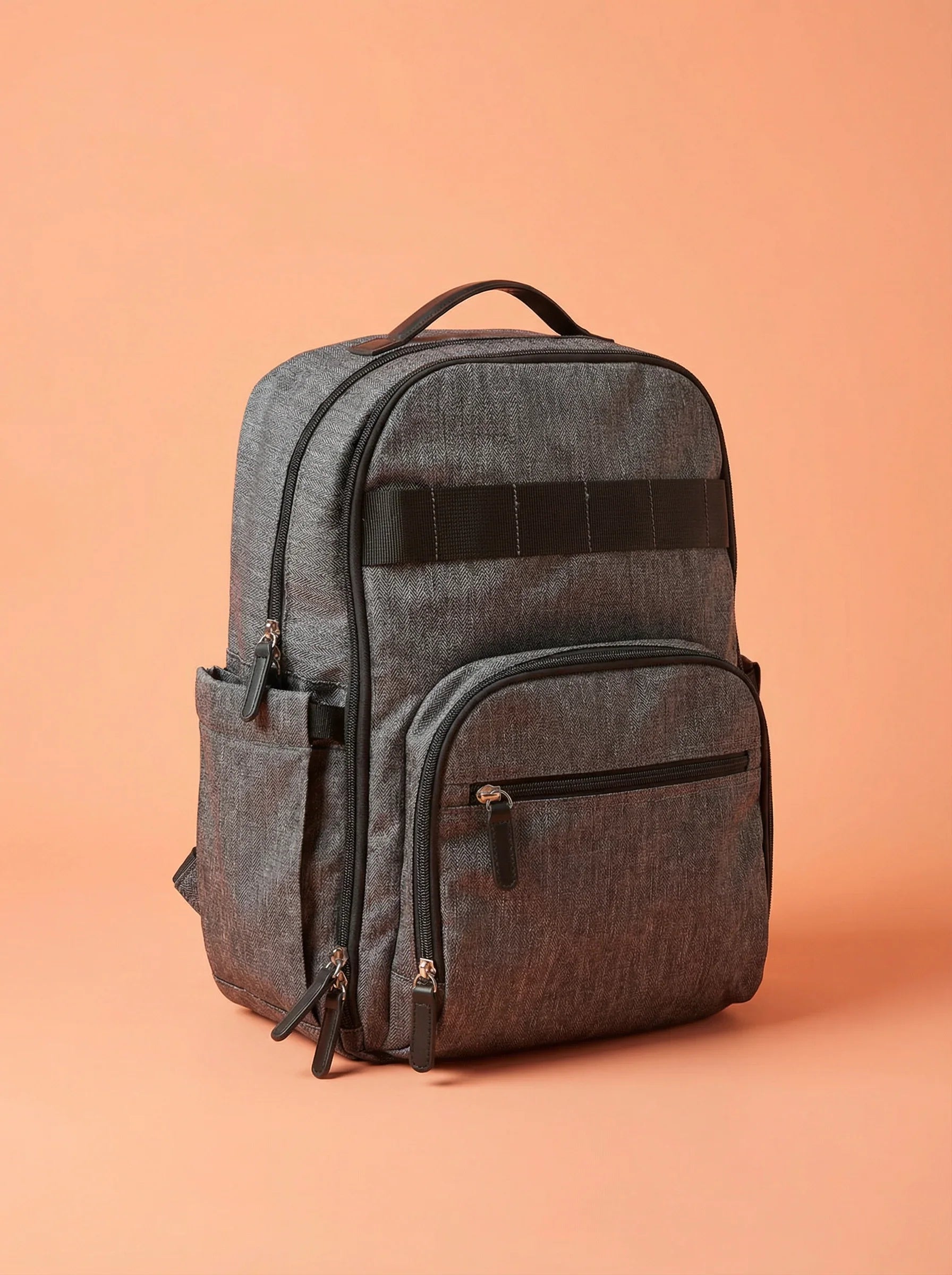 Bebefit Multipurpose Diaper Bag Backpack in dark grey on peach background, bebefit.eu