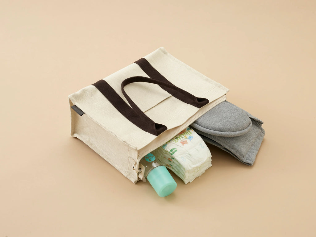 Bebefit Multi Pouch from bebefit.eu, cream organizer bag with diapers and baby essentials visible