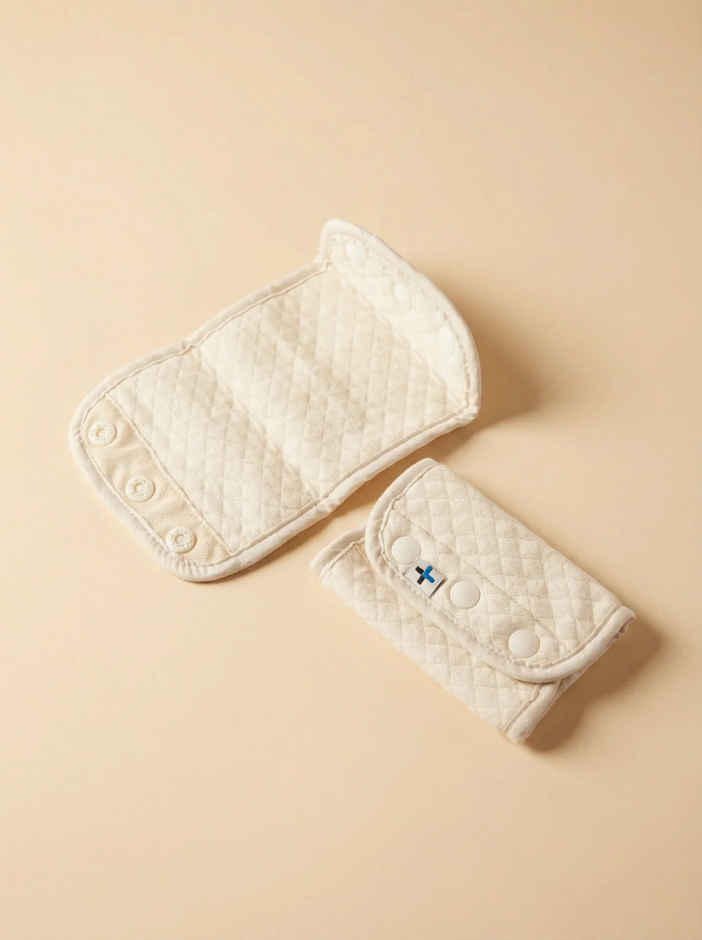 Bebefit.eu organic cotton teething pad for baby carrier, beige quilted fabric on neutral background