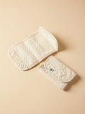 Bebefit.eu organic cotton teething pad for baby carrier, beige quilted fabric on neutral background